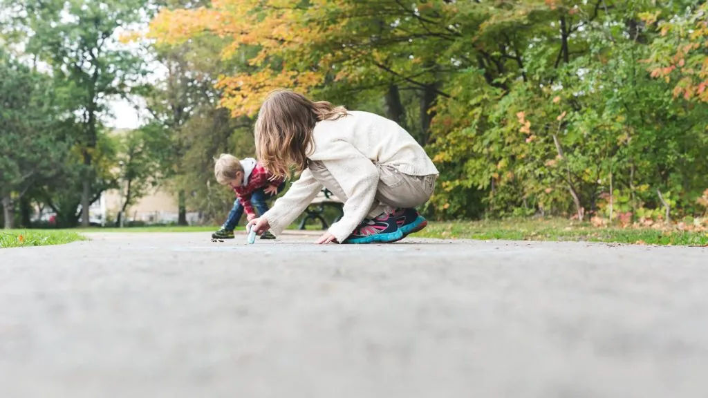 kids using chalk to write on the sidewalk