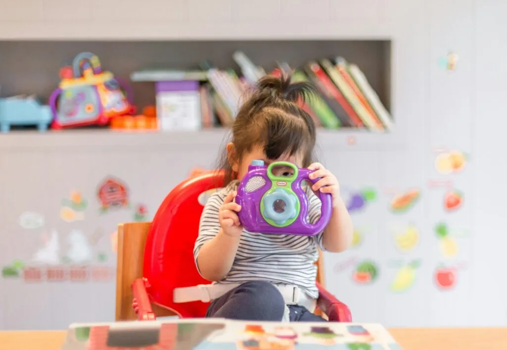 a child looking through a toy camera